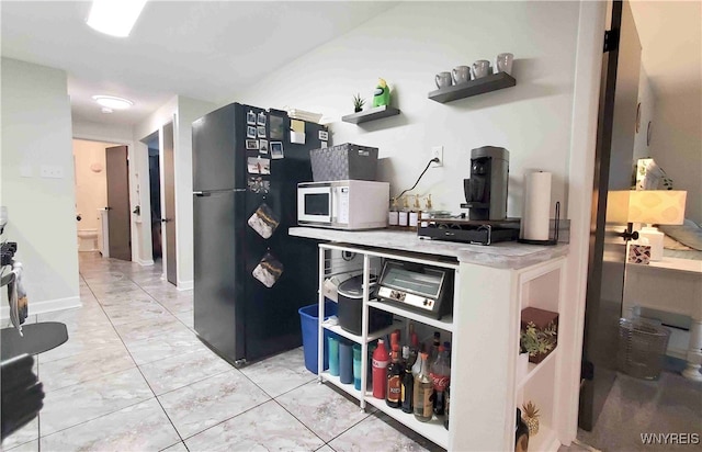 kitchen featuring black refrigerator