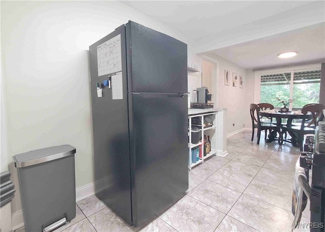 kitchen with black refrigerator