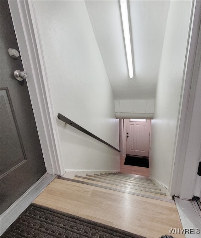 stairs featuring wood-type flooring