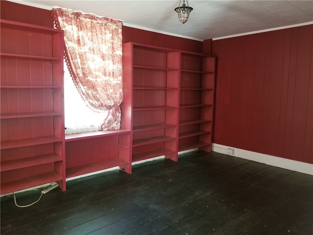 empty room featuring crown molding and dark hardwood / wood-style flooring