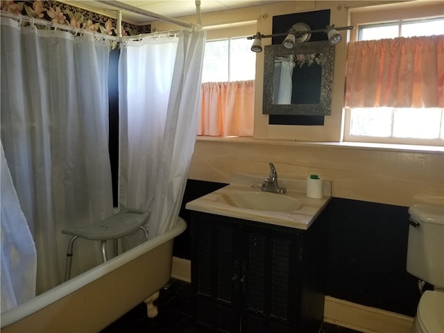 full bathroom featuring tile patterned flooring, shower / bathtub combination with curtain, toilet, and vanity