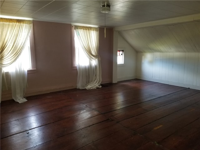 bonus room with vaulted ceiling and dark hardwood / wood-style floors