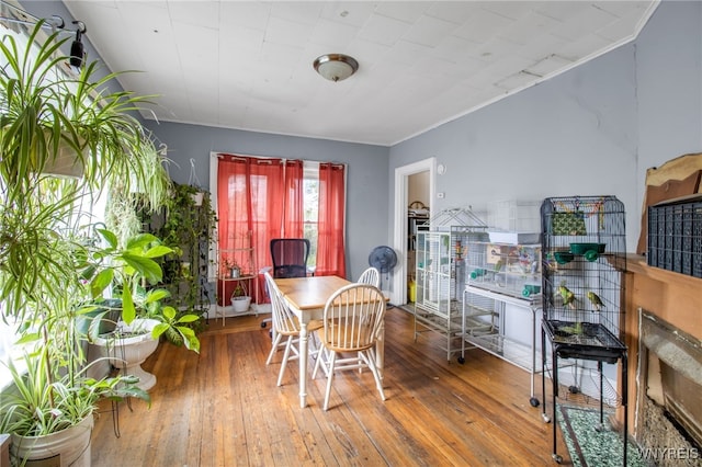 dining area featuring hardwood / wood-style floors and crown molding