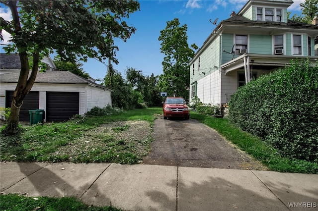 view of side of property featuring an outdoor structure and a garage