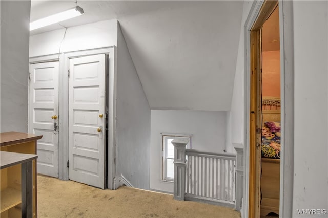 interior space with lofted ceiling and light colored carpet