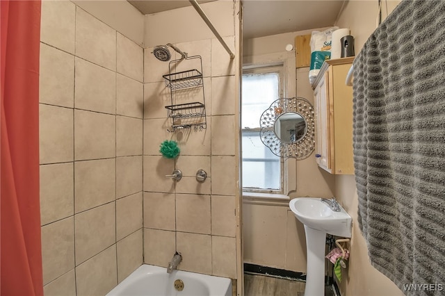 bathroom with shower / bath combo and a healthy amount of sunlight