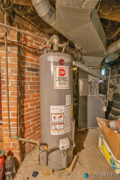 utility room featuring gas water heater and heating unit