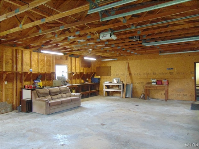 garage with a garage door opener and a workshop area