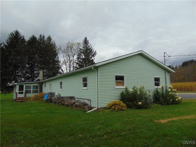 view of home's exterior with a lawn