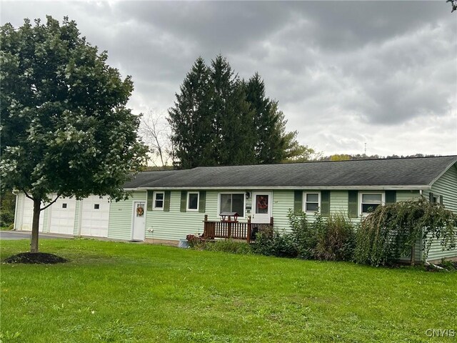 single story home with a garage and a front yard