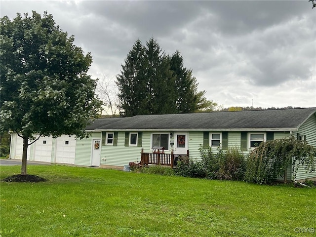 ranch-style home with a garage and a front lawn