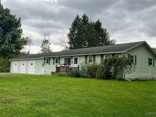 ranch-style house featuring a garage and a front lawn