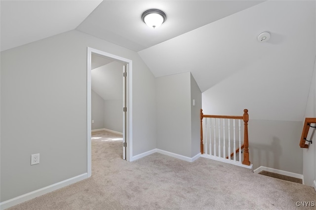 additional living space with lofted ceiling and light colored carpet