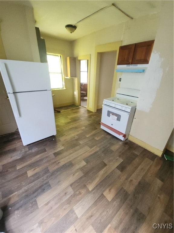 kitchen featuring white appliances and dark hardwood / wood-style flooring