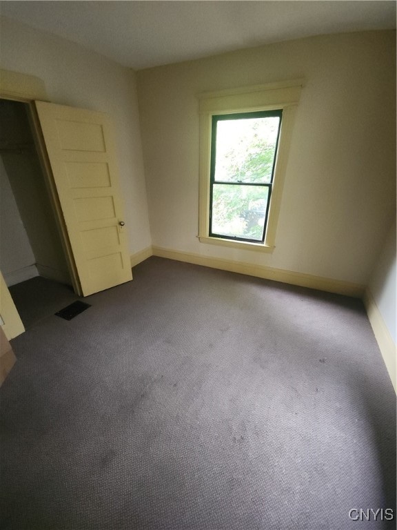 unfurnished bedroom with carpet floors and a closet