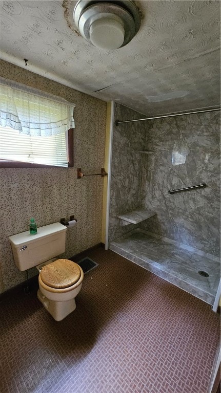 bathroom with a shower and toilet