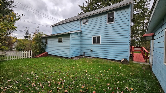 rear view of property featuring a yard