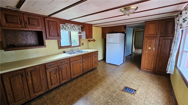 kitchen featuring white refrigerator and sink