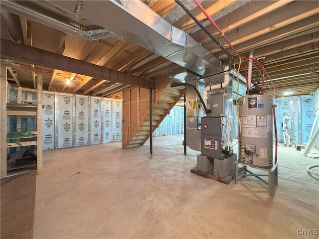 basement featuring heating unit and water heater