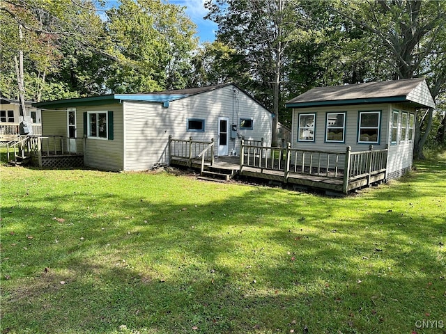 back of property with a yard and a deck