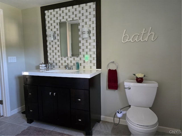 bathroom with vanity, toilet, tasteful backsplash, and tile patterned floors