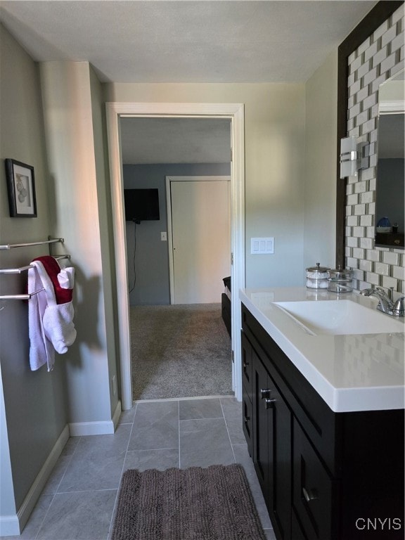 bathroom featuring vanity, tile patterned flooring, and decorative backsplash