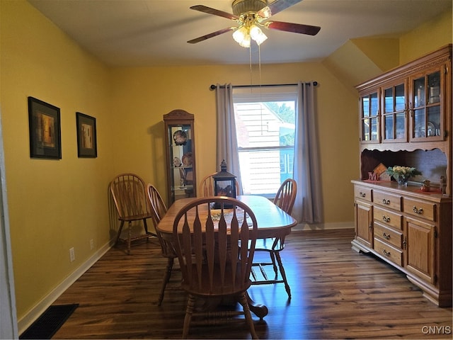 dining space featuring vaulted ceiling, ceiling fan, and dark wood-type flooring