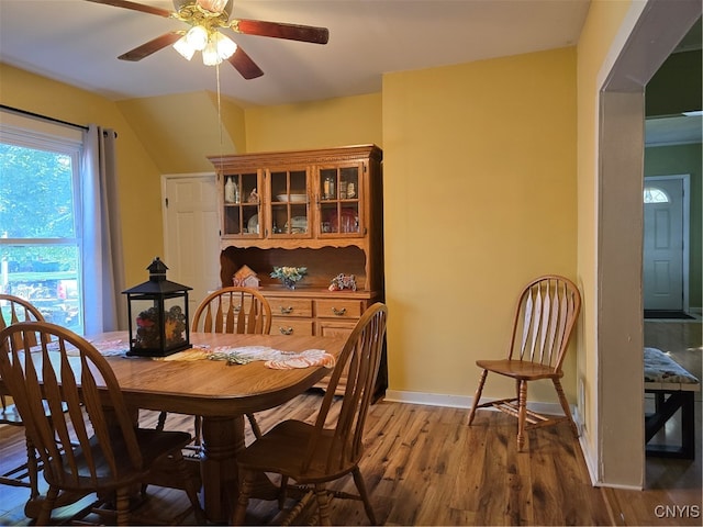 dining area with wood-type flooring and ceiling fan