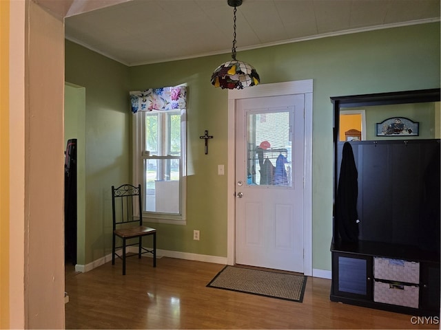 foyer entrance with hardwood / wood-style flooring and crown molding