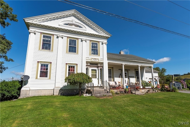 view of front facade with covered porch and a front yard