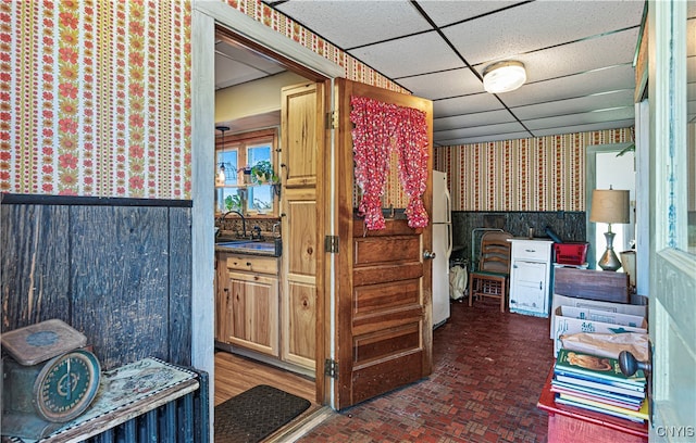 bathroom with a paneled ceiling and sink