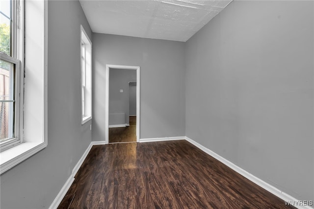 spare room with dark hardwood / wood-style flooring