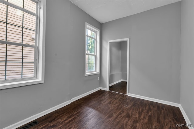 spare room featuring dark hardwood / wood-style flooring