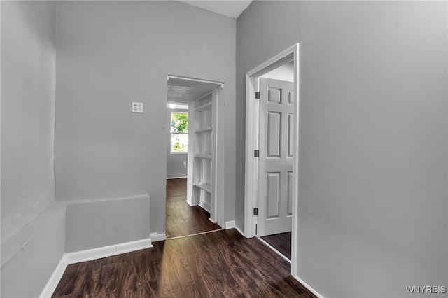 hallway with dark wood-type flooring