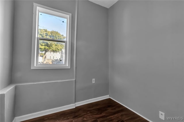 empty room with dark wood-type flooring