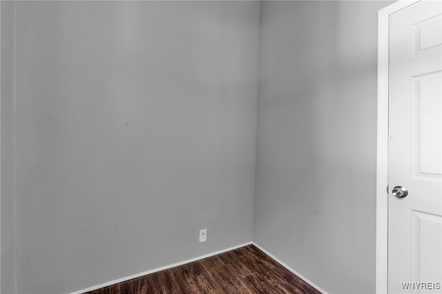 spare room with dark hardwood / wood-style flooring