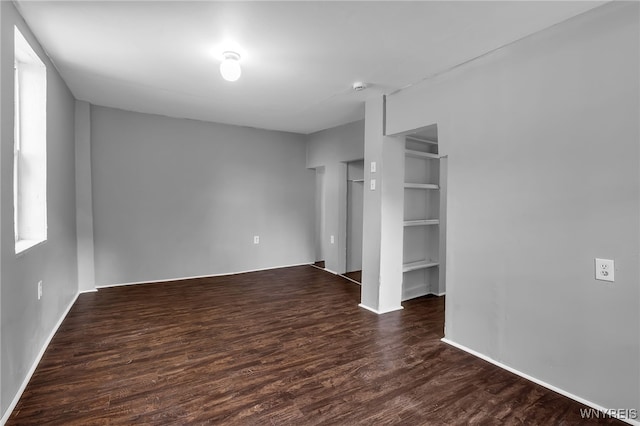 unfurnished bedroom with dark hardwood / wood-style flooring