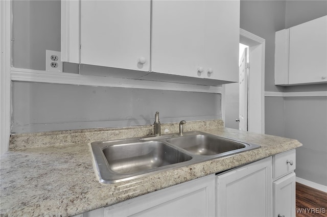 kitchen with white cabinets, sink, and dark hardwood / wood-style flooring