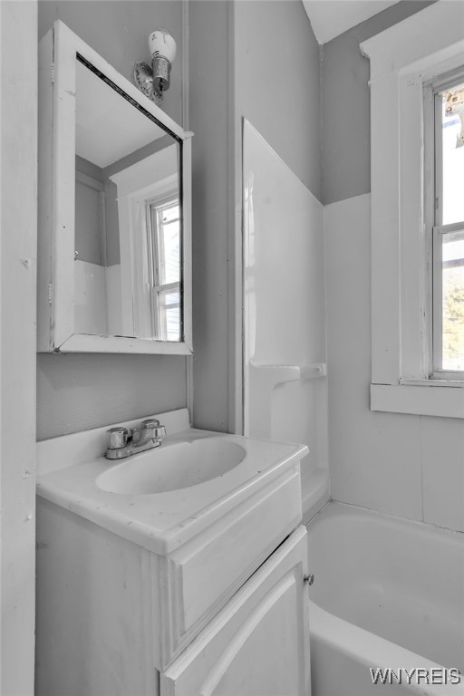 bathroom featuring vanity and a washtub