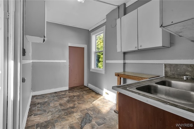 kitchen featuring white cabinets and sink