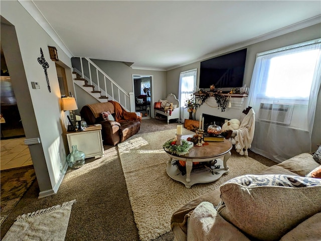 living room featuring ornamental molding, cooling unit, carpet, and a healthy amount of sunlight