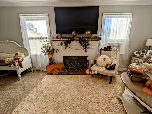 carpeted living room with a fireplace