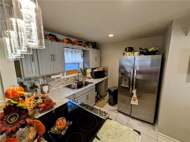 kitchen with stainless steel appliances, backsplash, sink, and gray cabinetry