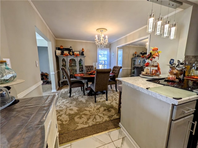 dining room featuring ornamental molding and a notable chandelier