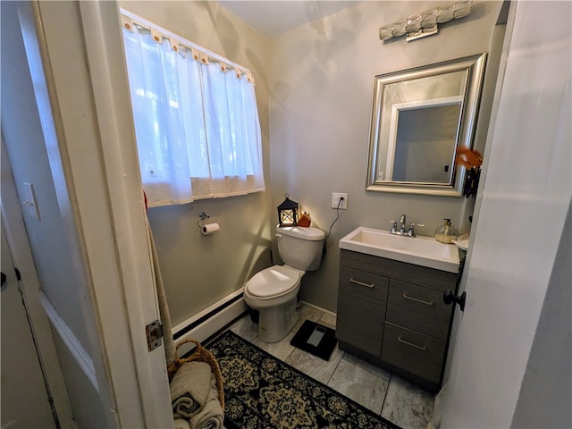 bathroom featuring vanity, toilet, and a baseboard heating unit