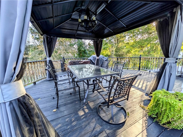 wooden deck with a gazebo and a grill