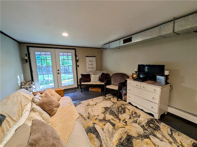 living room with french doors, baseboard heating, and ornamental molding