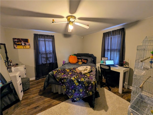 bedroom with ceiling fan and dark hardwood / wood-style flooring