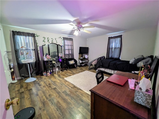 bedroom with ceiling fan and hardwood / wood-style flooring