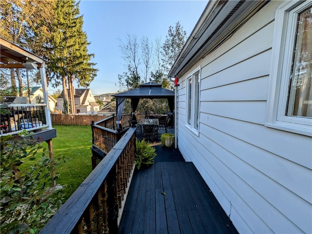 wooden terrace with a gazebo and a yard